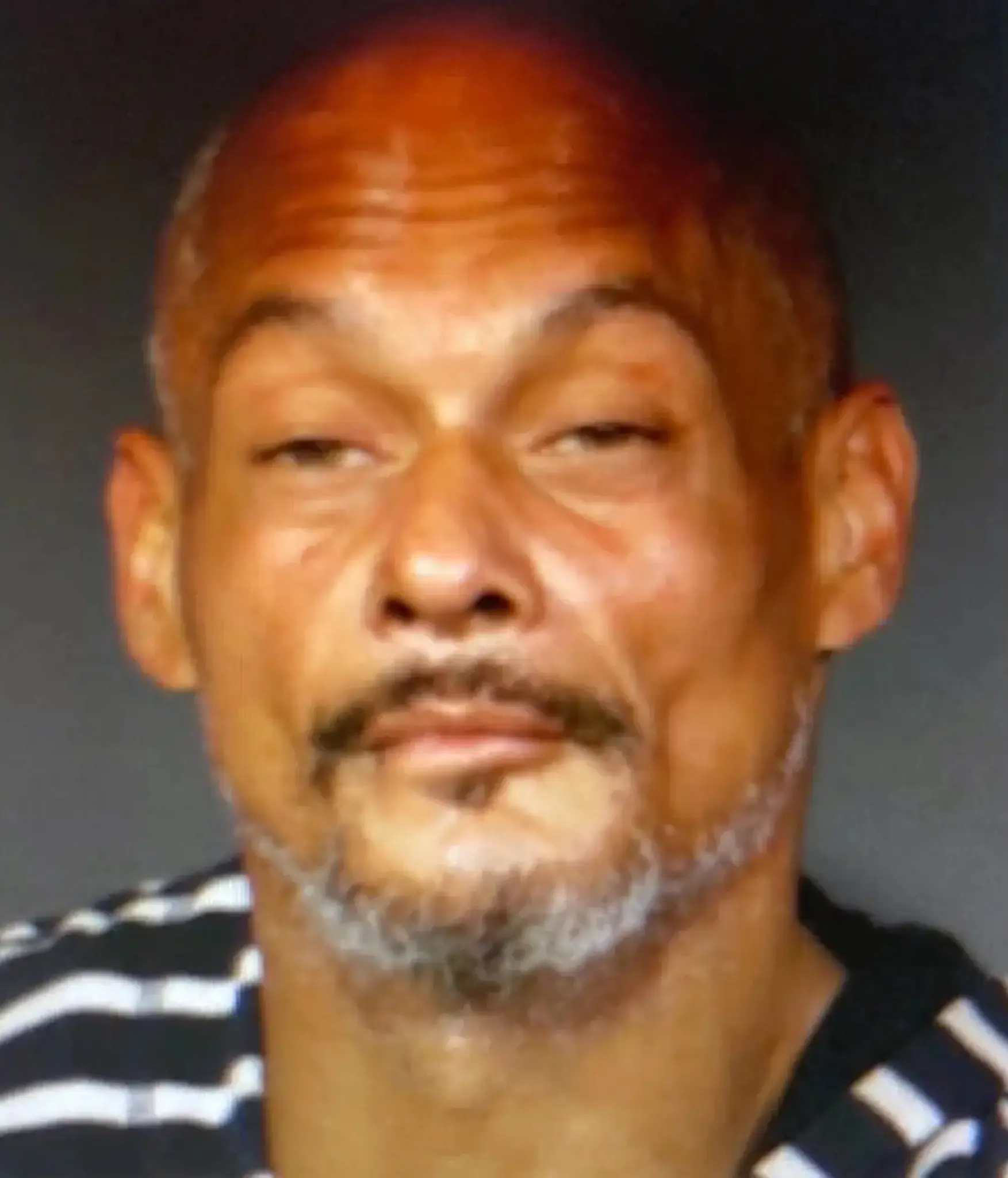 A suspected serial shoplifter, known for targeting local drugstores, appears in a police mugshot.